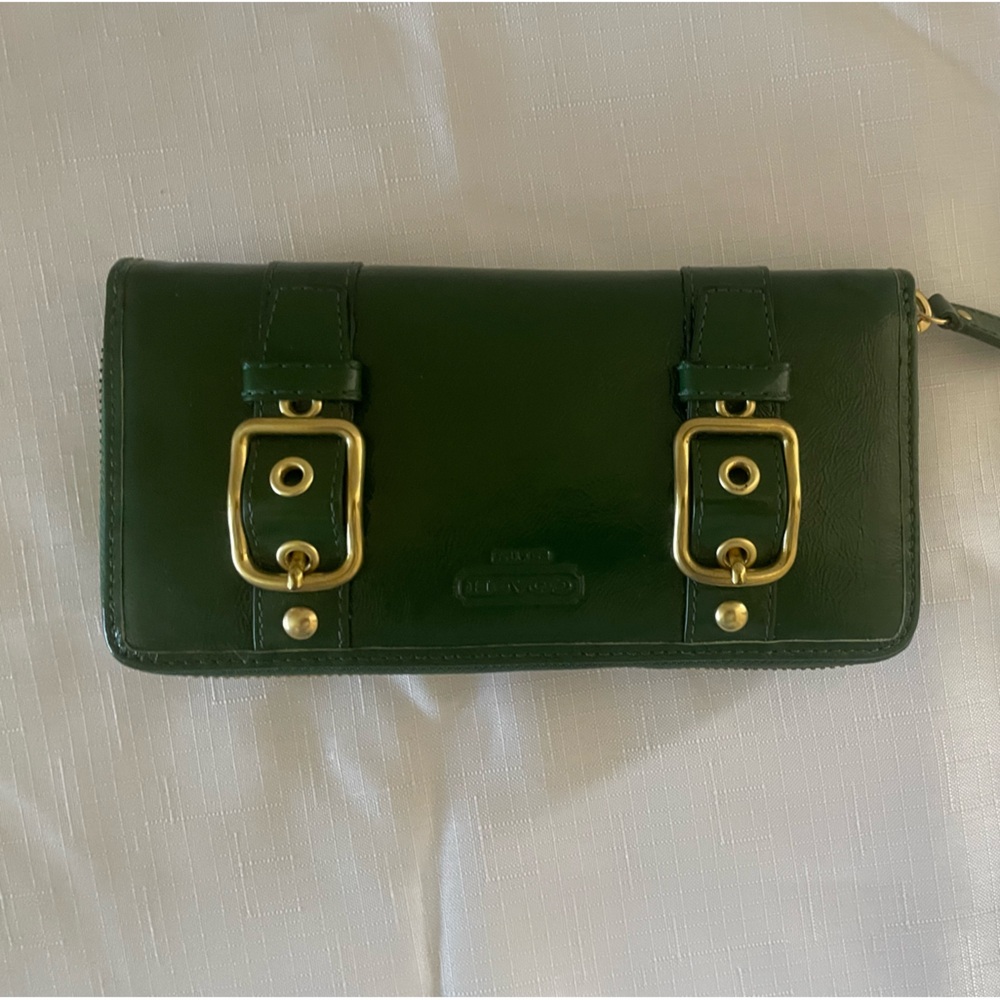 Dark green Coach wristlet with gold accents.